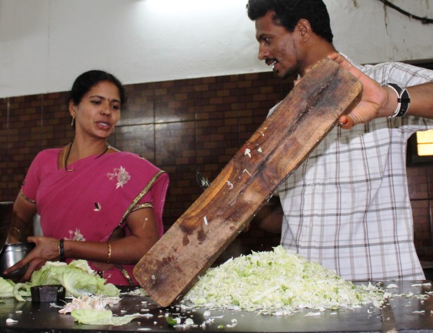 The kitchen staff working hard to make breakfast for 100 people!