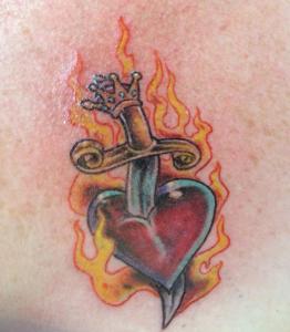 The King's sword (see the crown on the handle) stabs her heart.